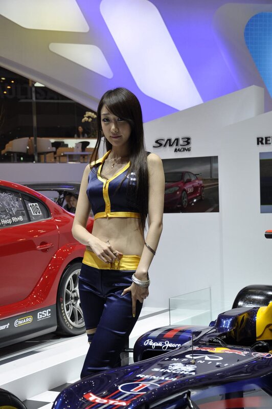 Woman at auto show with race car