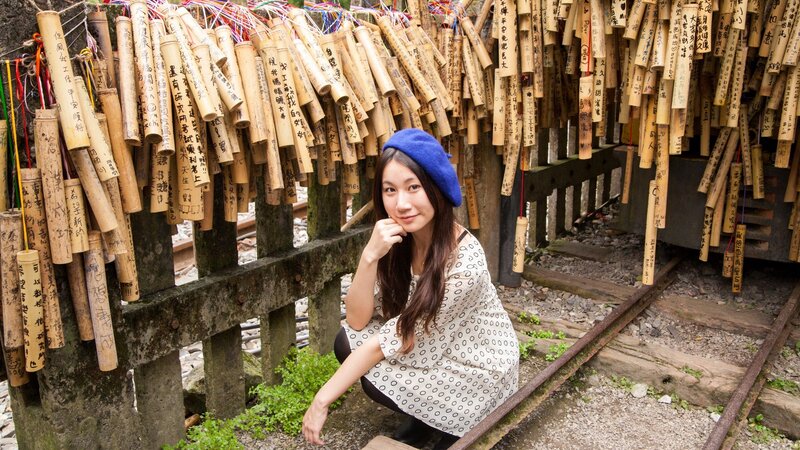 Woman at bamboo wish sticks