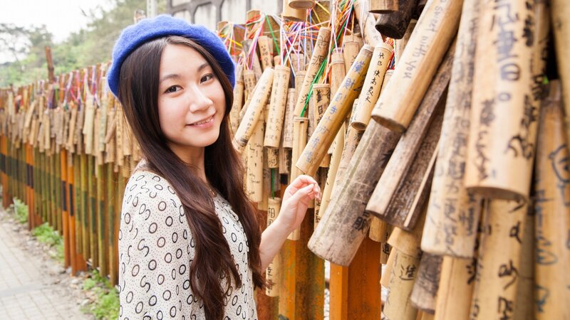 Woman at bamboo wish wall