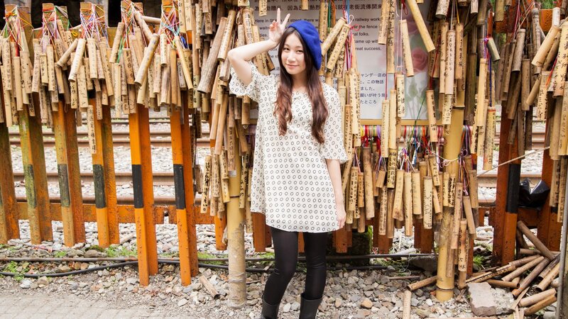 Woman at bamboo wish wall