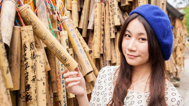 Woman at bamboo wish wall