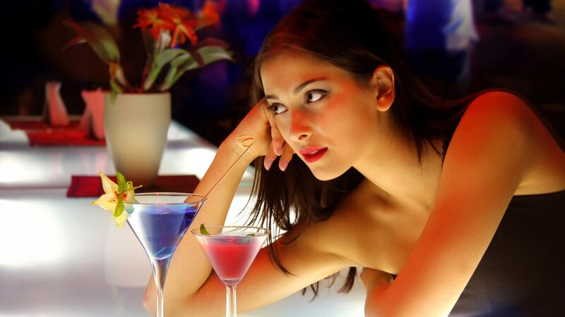 woman at bar with cocktails