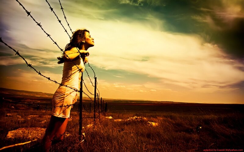woman at barbed wire fence