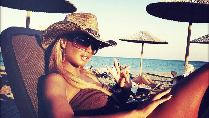 Woman at beach in cowboy hat