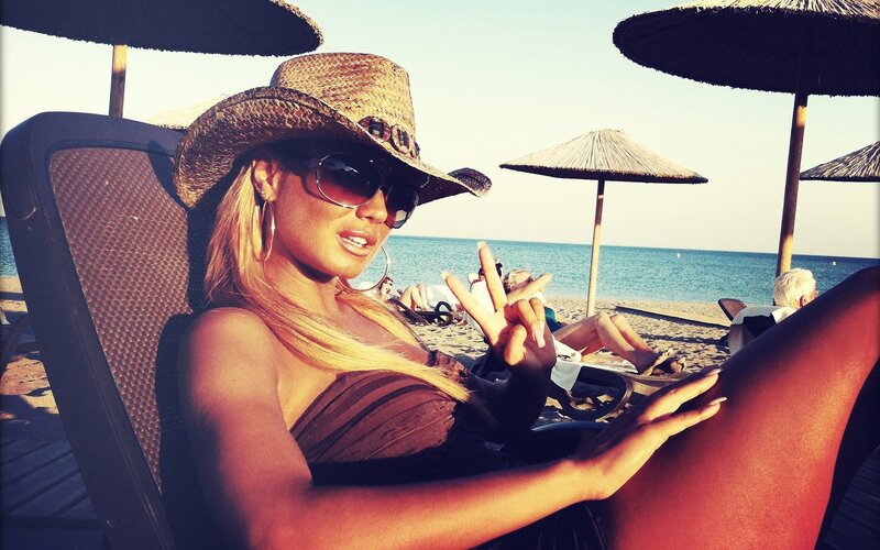 Woman at beach in cowboy hat