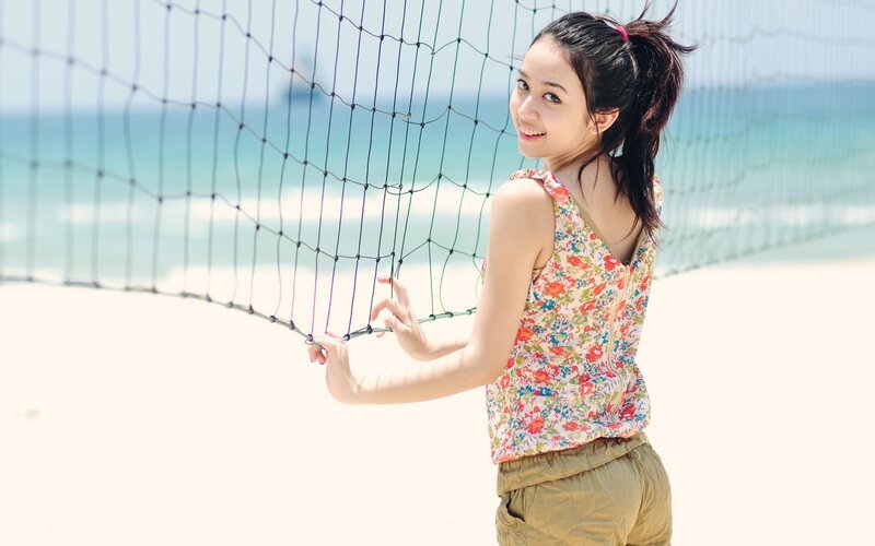 Woman at beach volleyball net