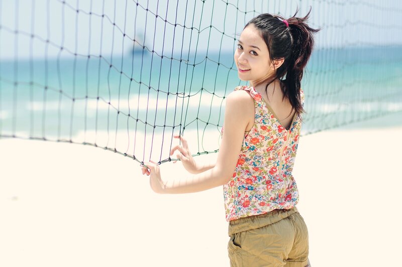 Woman at beach volleyball net