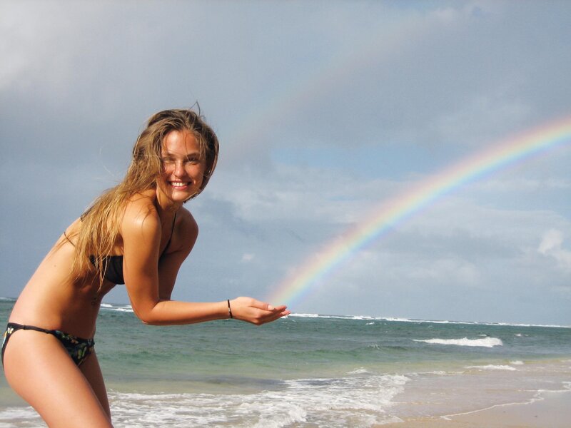 Woman at beach with rainbow