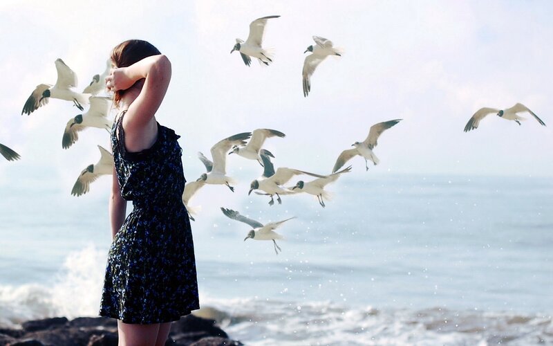 woman at beach with seagulls