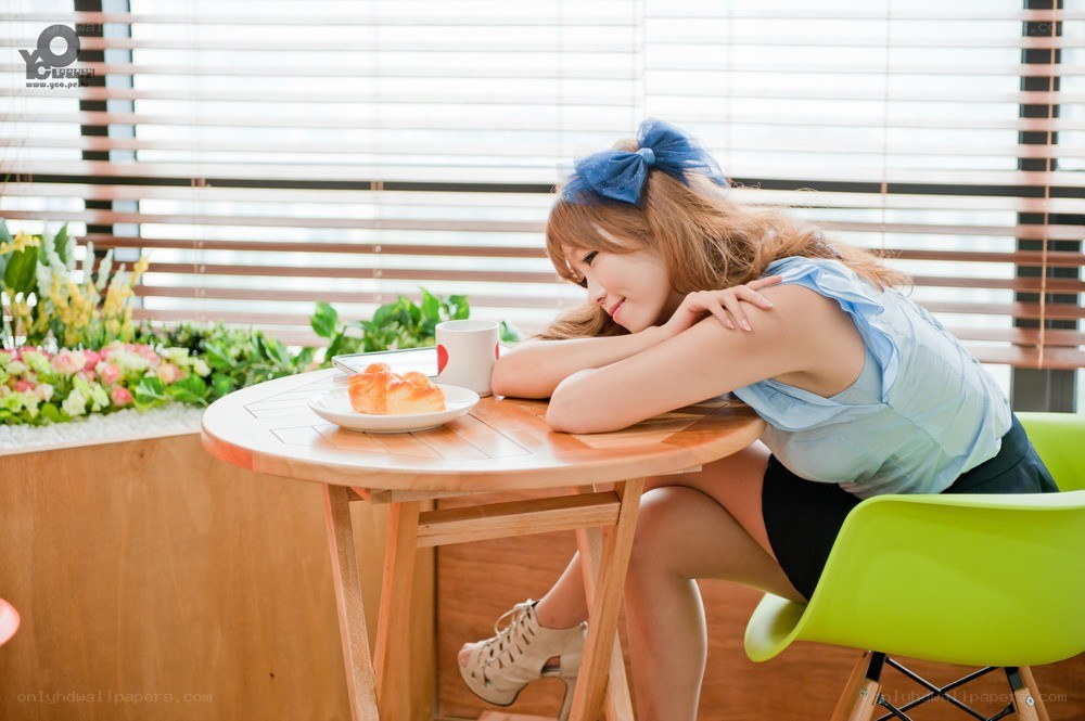 woman at cafe table with pastry