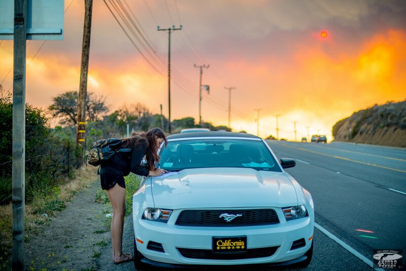 Woman at car during wildfire