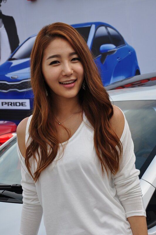 woman at car event smiling