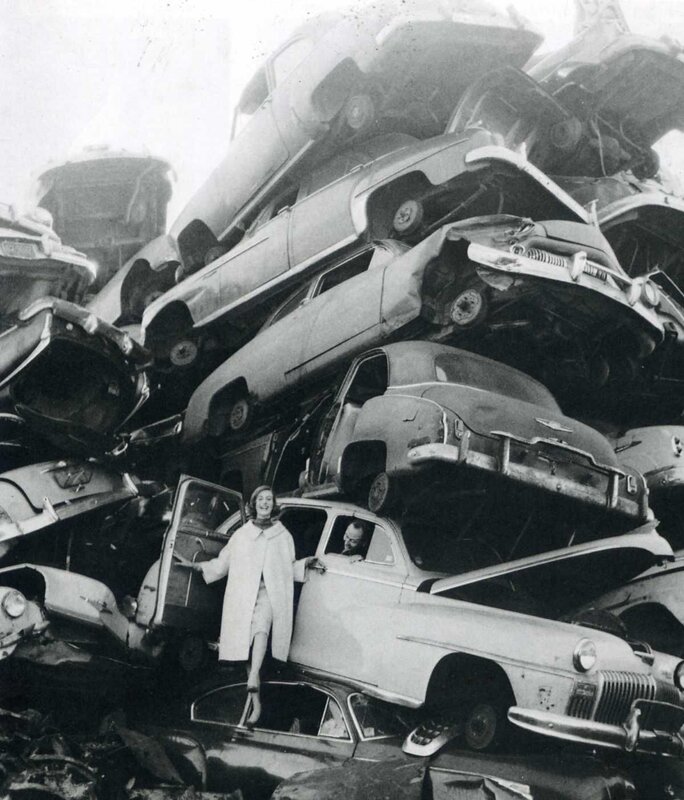 Woman at car junkyard