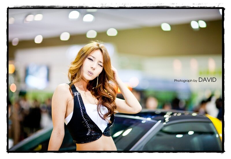 Woman at Car Show — Black, Lively, Photograph, Crowd, Lighting