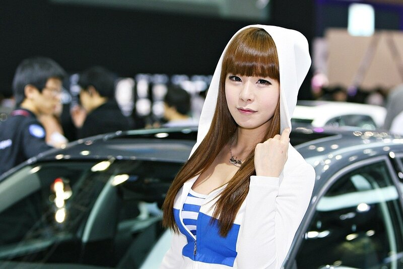 Woman at car show in white hoodie
