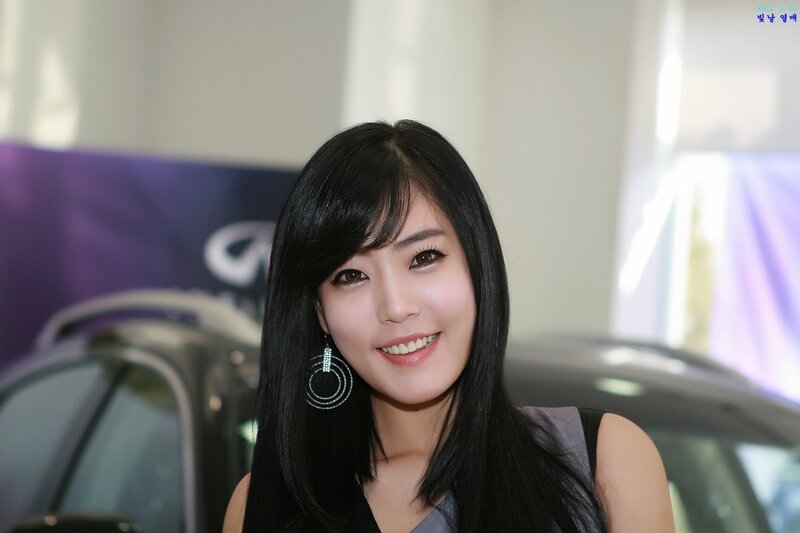 woman at car show smiling