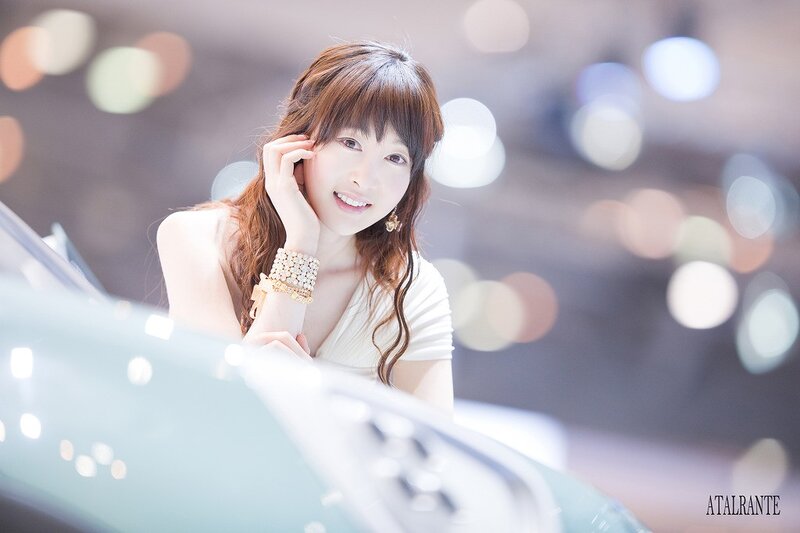 woman at car show smiling