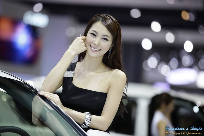 woman at car show smiling