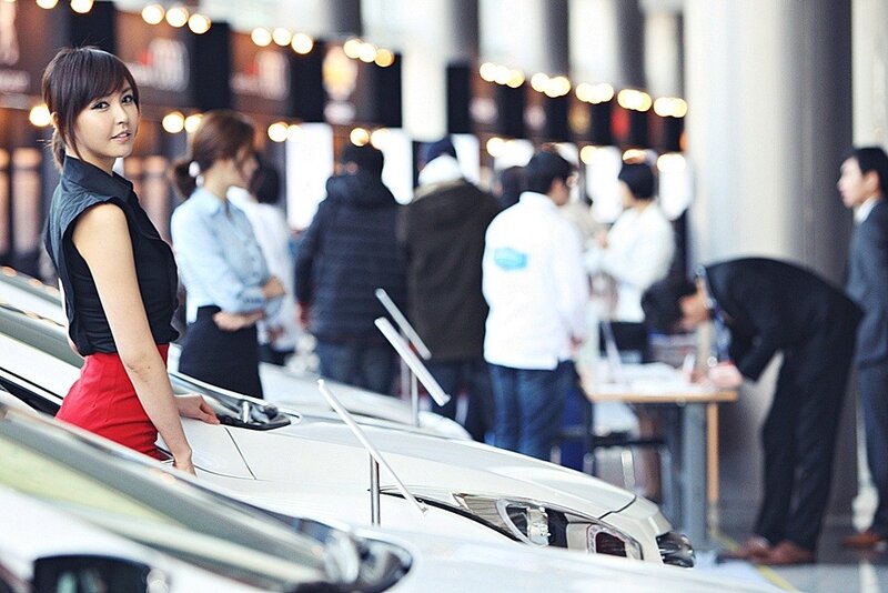 Woman at Car Show — White, Professional, Afternoon