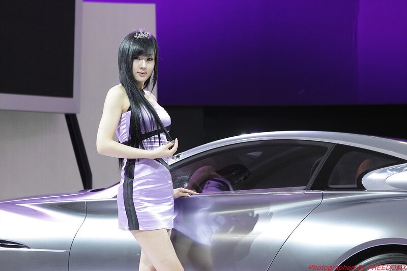 Woman at car show with concept car