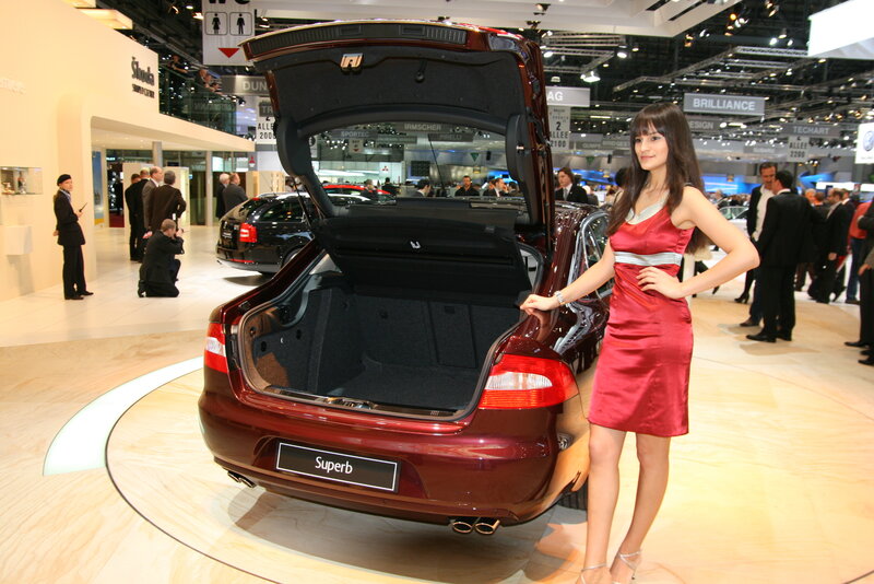 Woman at car show with open trunk