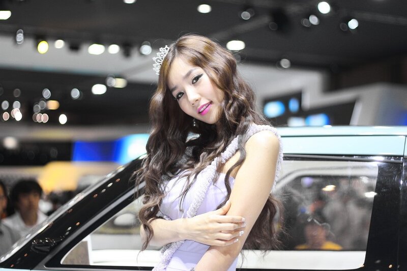 Woman at car show with tiara
