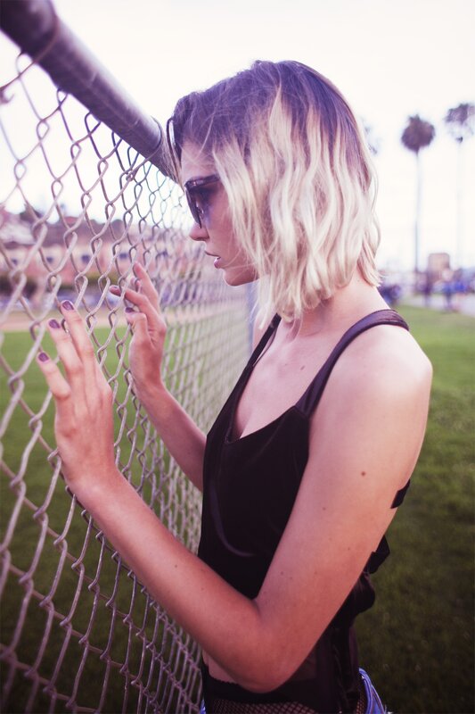 woman at chain-link fence