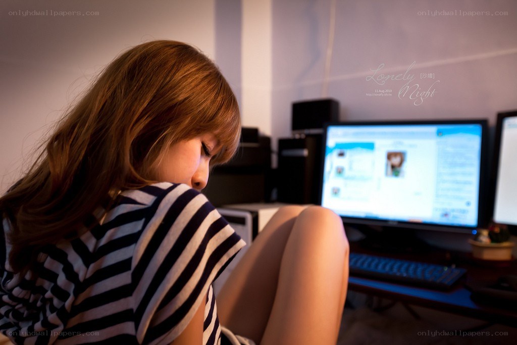 woman at computer in dim light