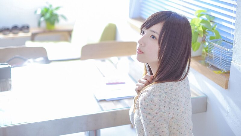 woman at desk in sunlit room