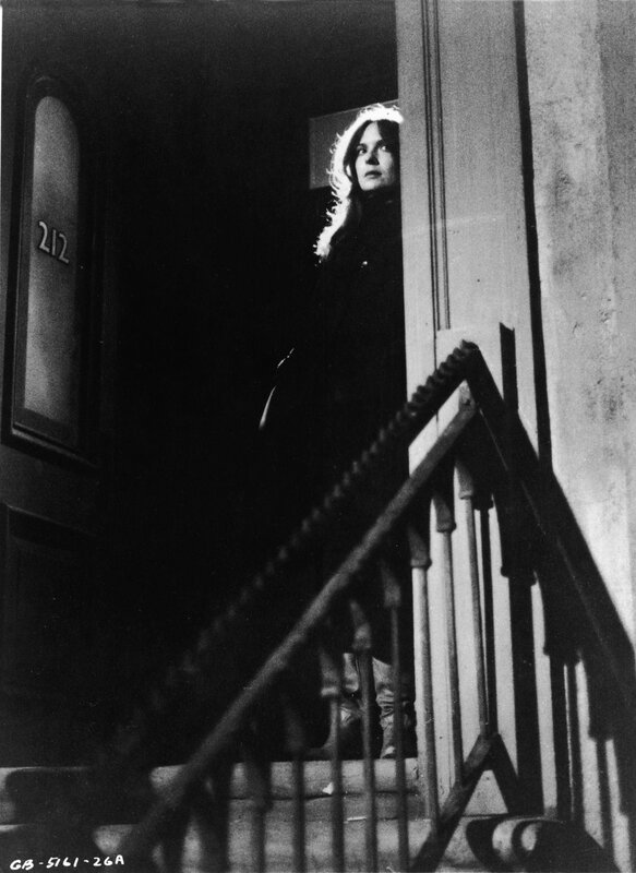 woman at doorway on stairs