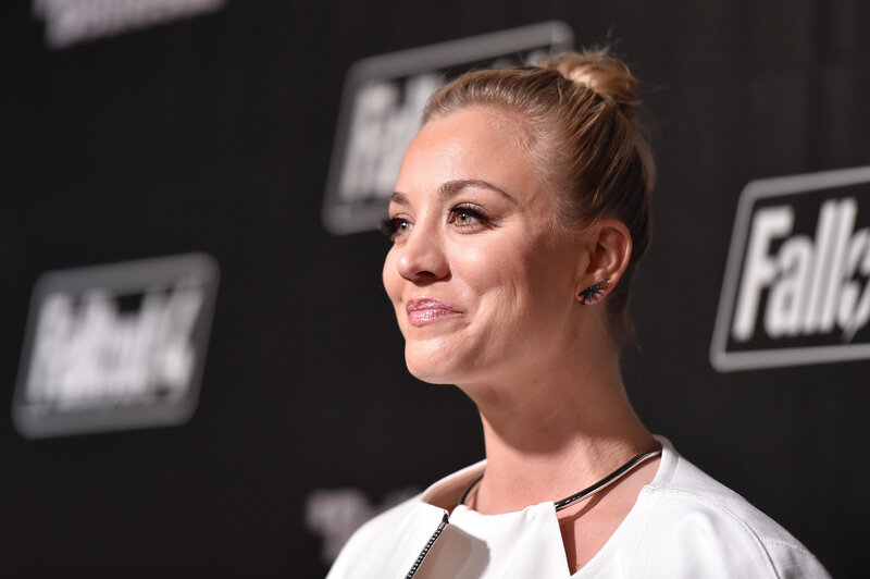 woman at event with logo backdrop