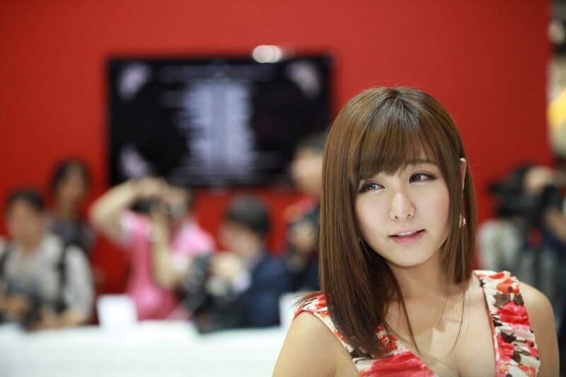 Woman at event with red background