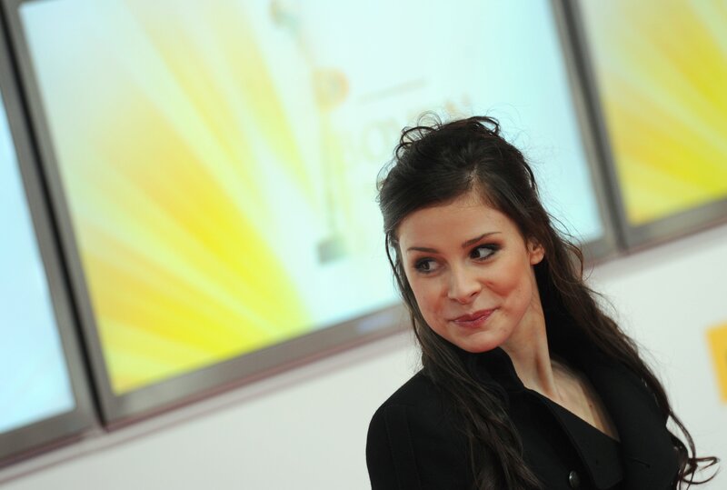woman at event with yellow backdrop
