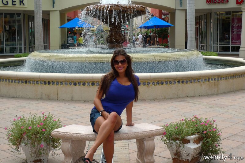 Woman at fountain in shopping area