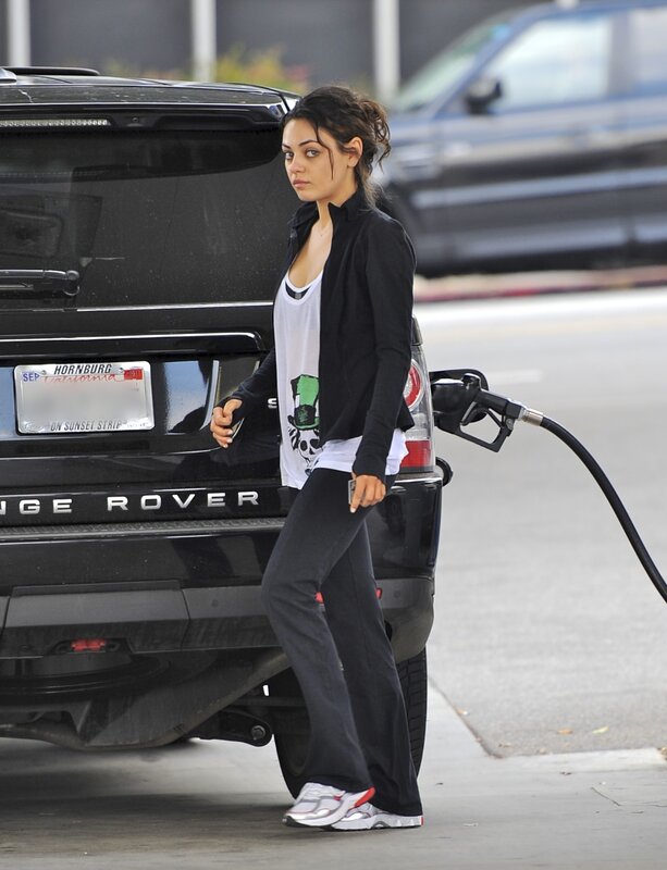 woman at gas station with SUV