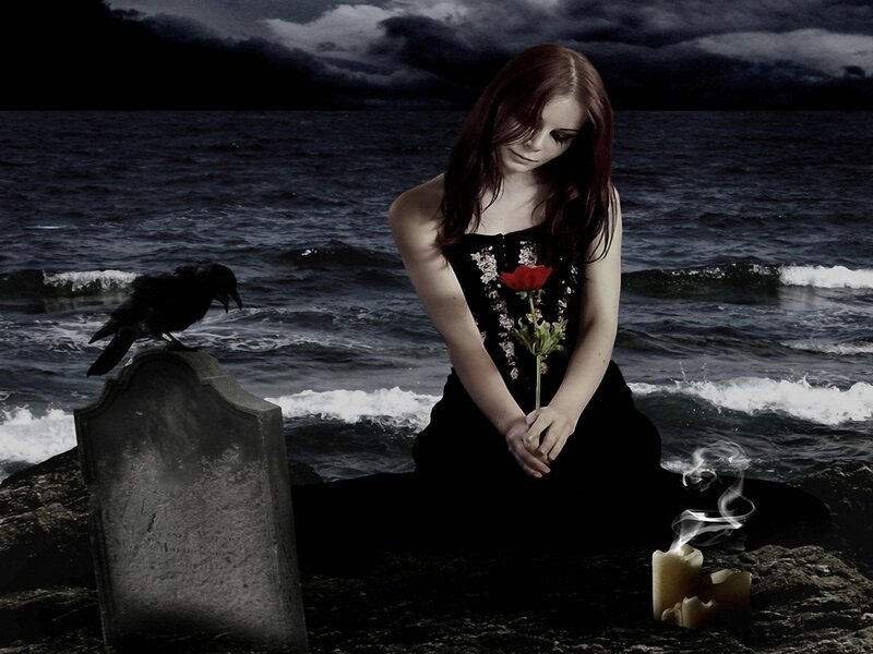 woman at graveside by the sea