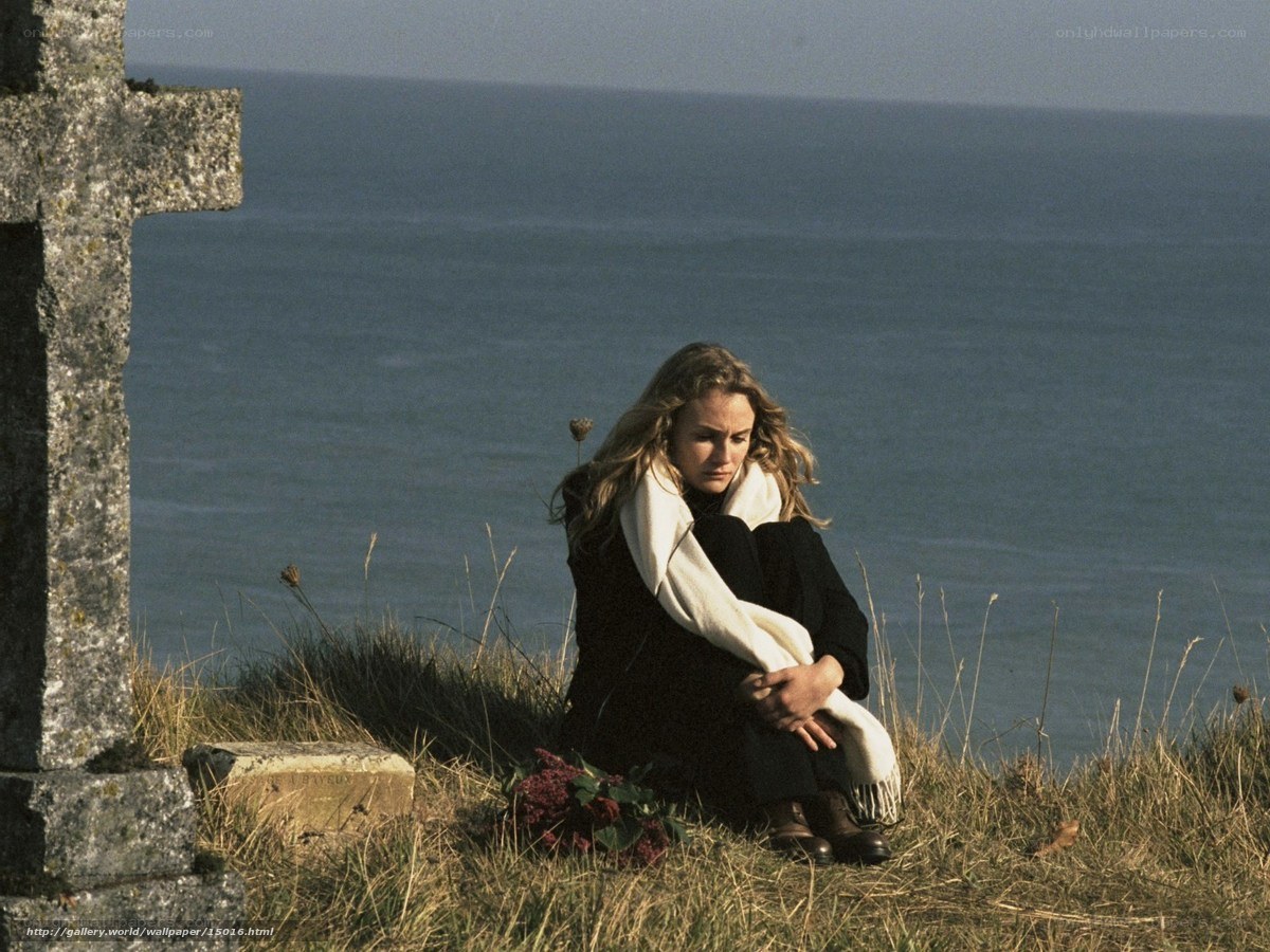 Woman at graveside by the sea