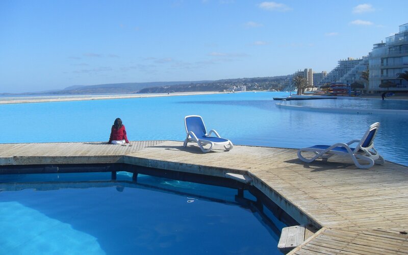 Woman at infinity pool by the sea
