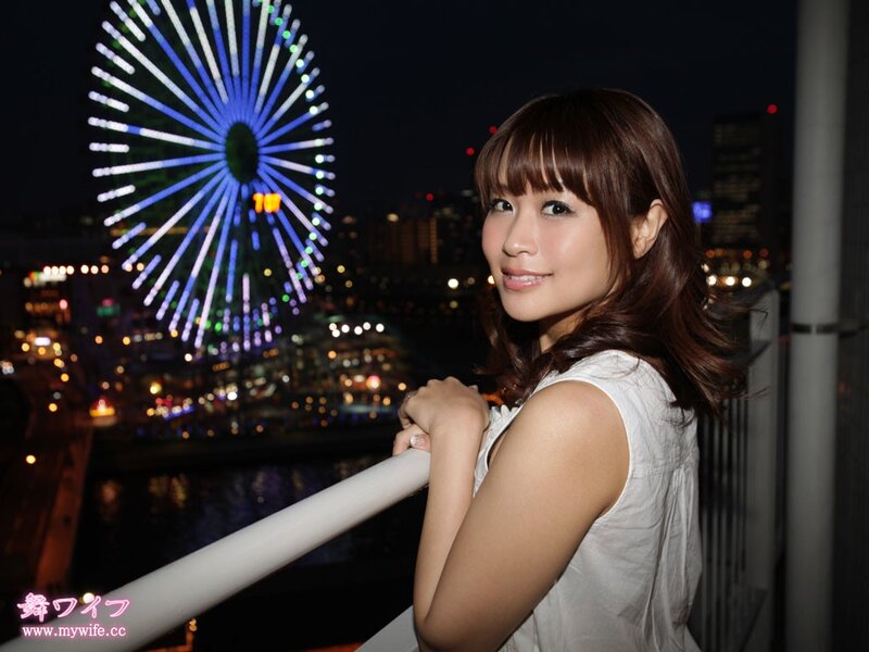 Woman at night with ferris wheel