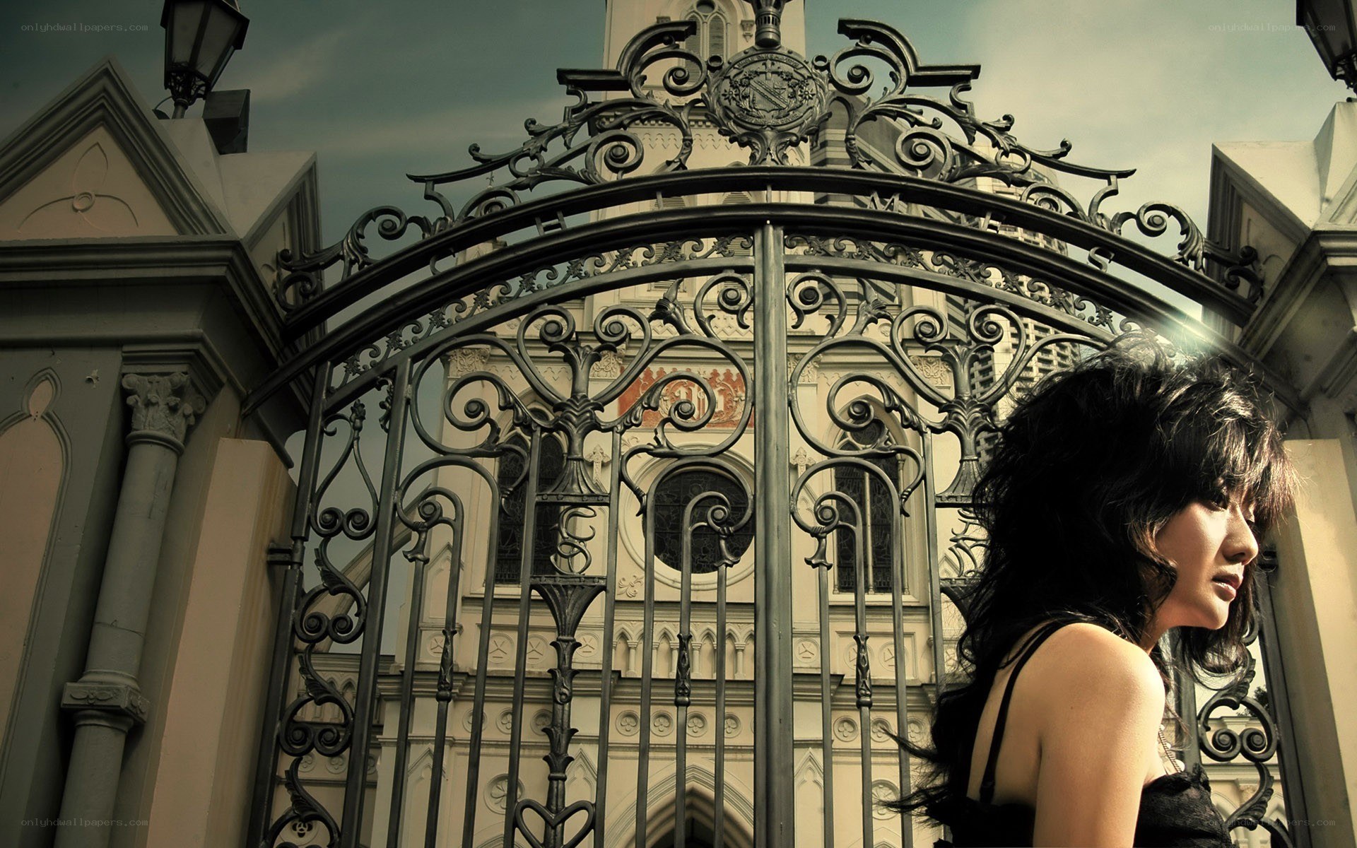 Woman at ornate gate