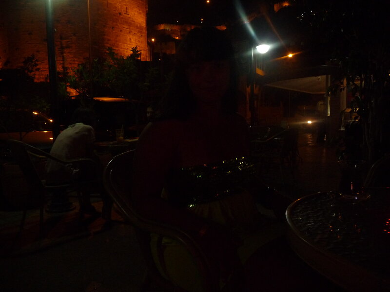woman at outdoor cafe at night