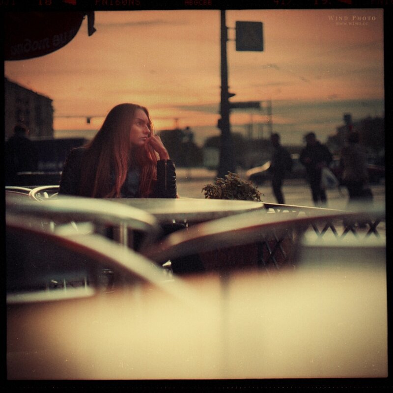 woman at outdoor cafe at sunset