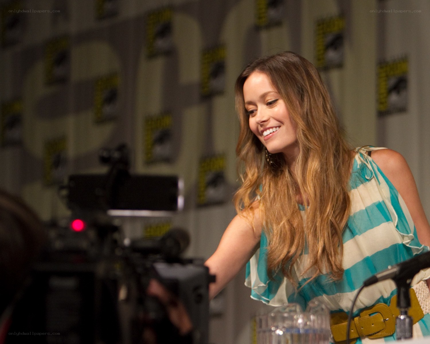 woman at panel event smiling