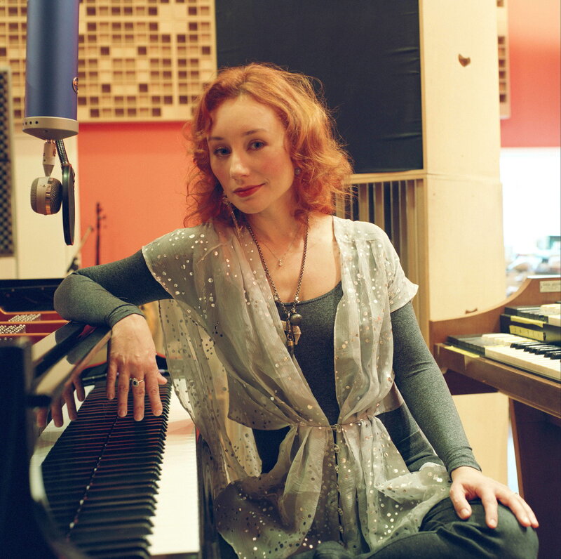 woman at piano in recording studio