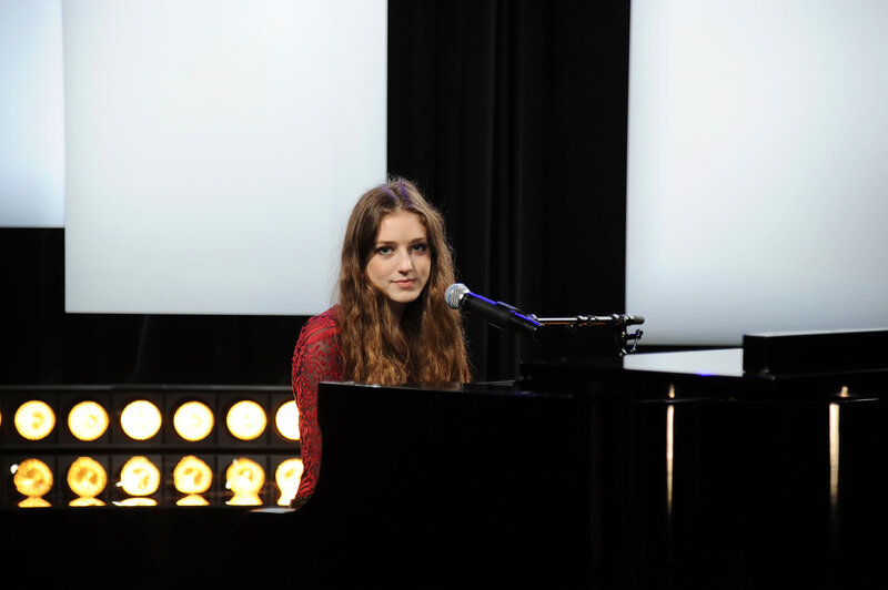 woman at piano on stage