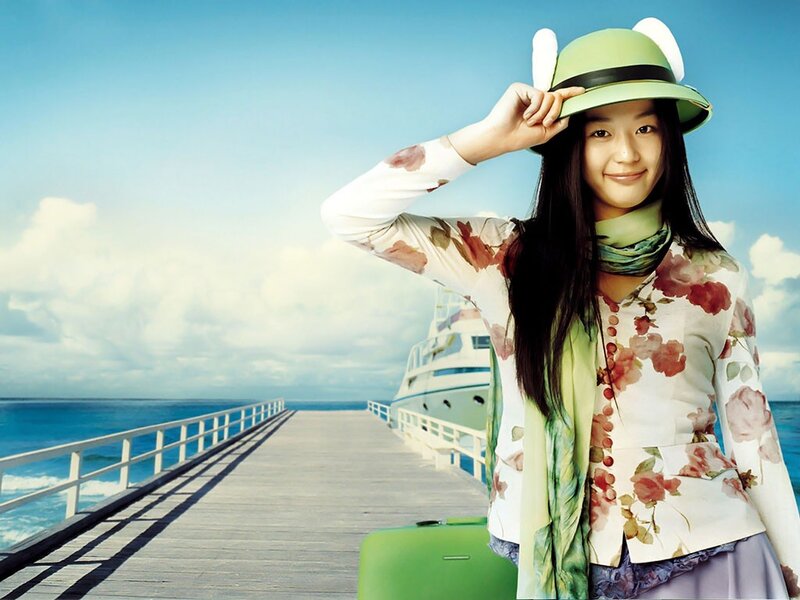 woman at pier with suitcase
