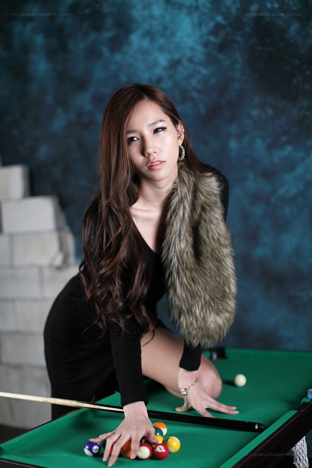 woman at pool table with balls