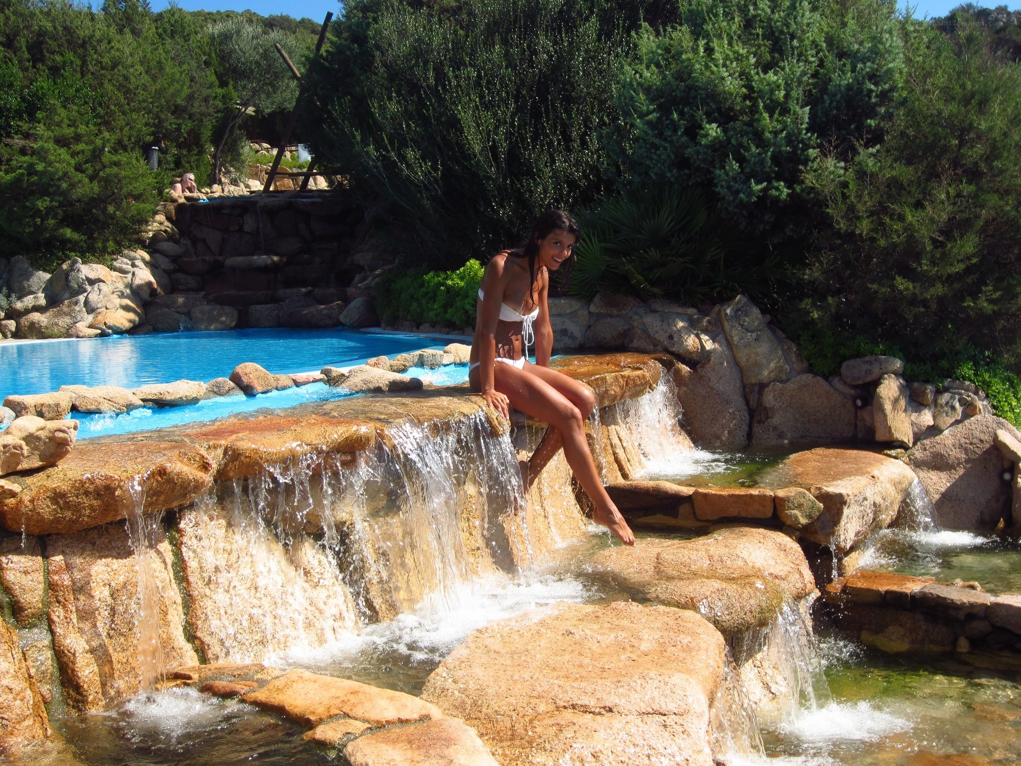 Woman at pool waterfall