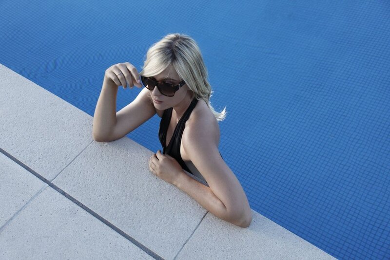 Woman at poolside in sunglasses