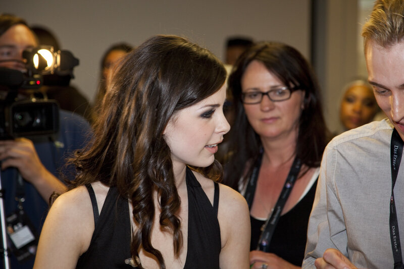 Woman at public event signing autograph